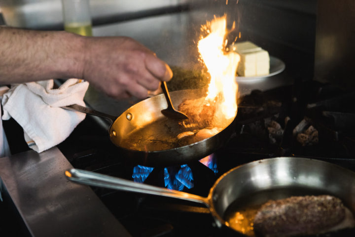 Fire coming from a hot pan on the stove