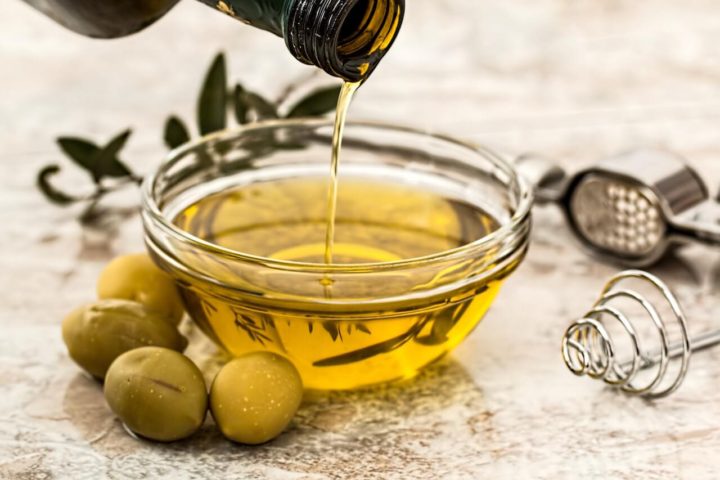 Pouring oil into small glass dish container